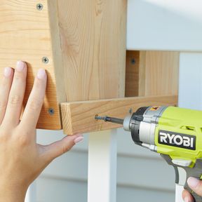 inserting screw with electric drill for wood box planter