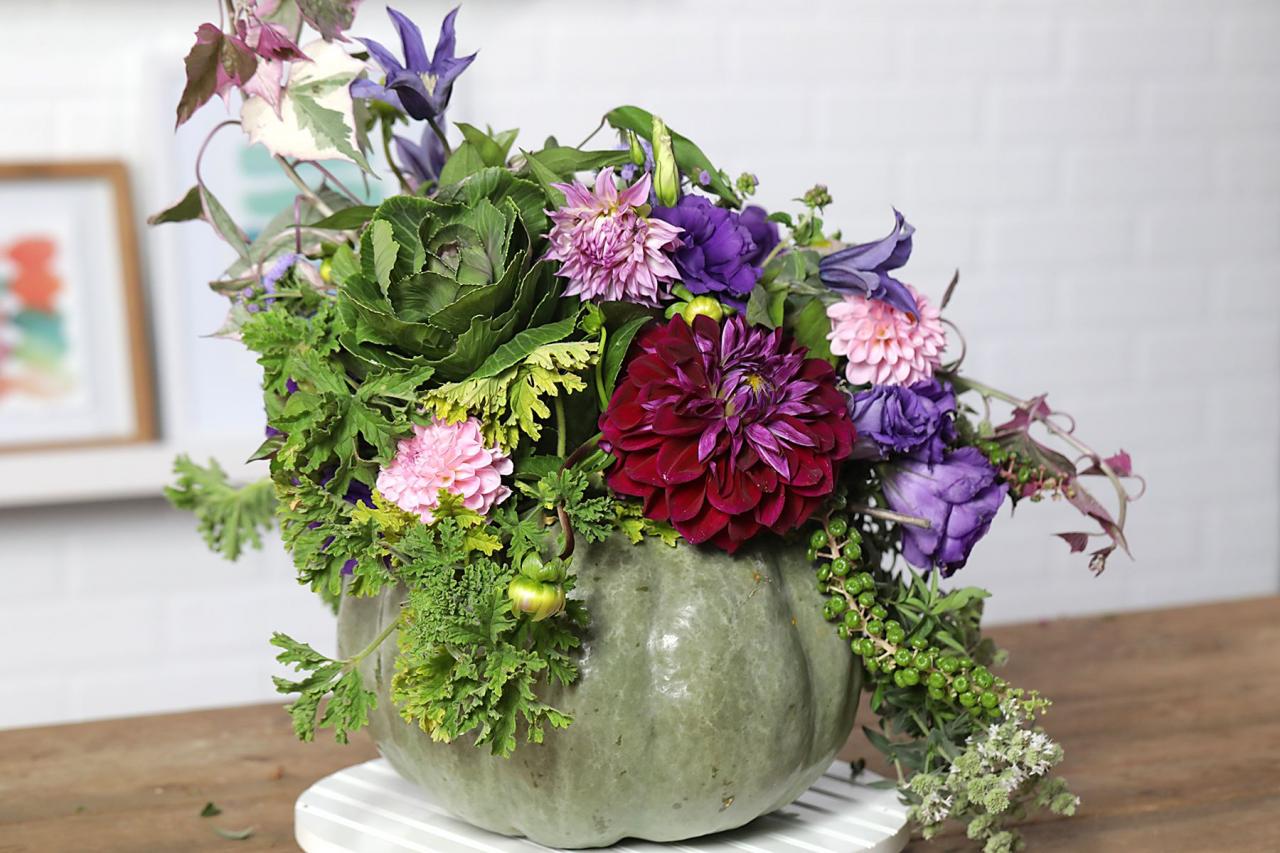 various shades of purple and pink flowers in round green pot