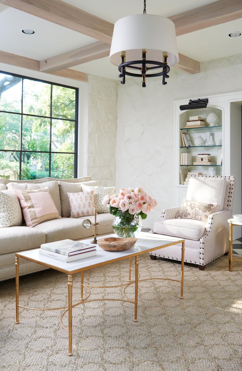 White living room with textured walls and soft pink furnishings