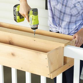 using electric drill to fasten porch wood planter