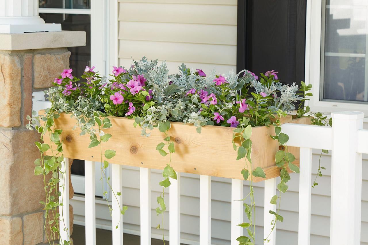 wood porch planter box with various flowers and hanging plants